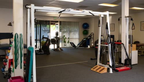 A room full of exercise equipment and equipment.