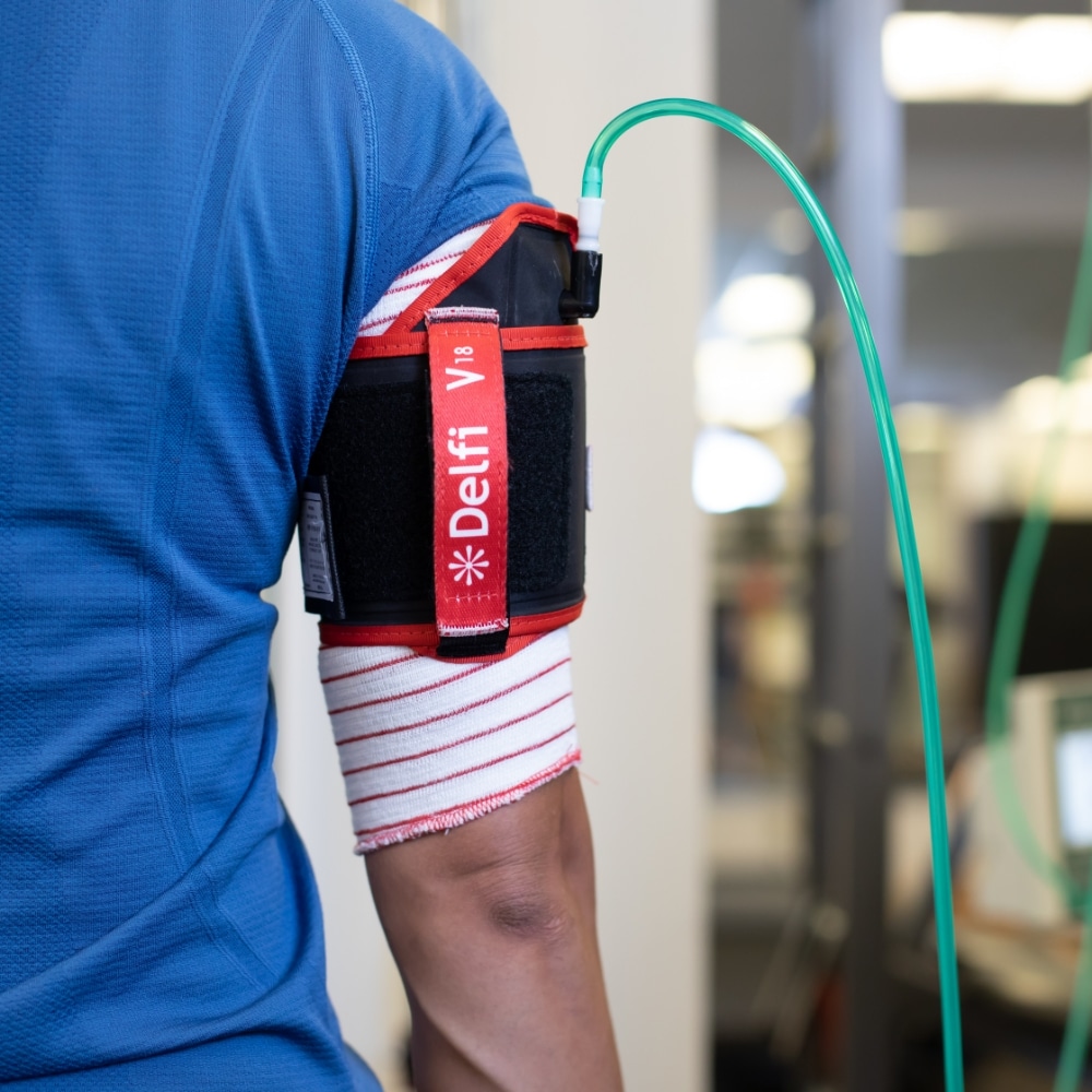 A man with a blood pressure cuff attached to his arm.