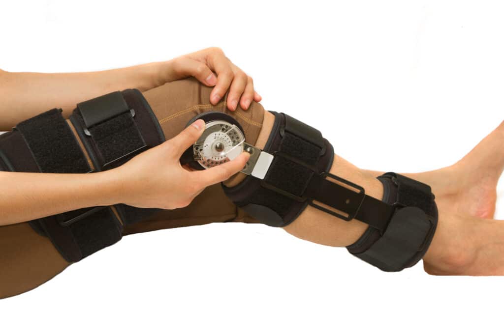 A woman wearing a knee brace with a clock on it.